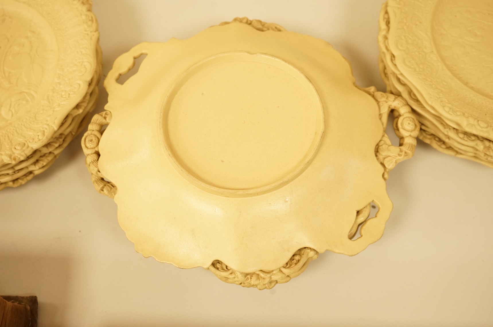 A Victorian drabware part dessert set, comprising eleven plates and three two handled dishes, dishes 25cm wide